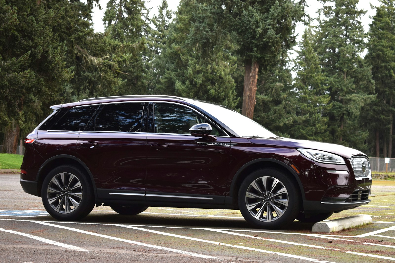 a maroon suv parked in a parking lot